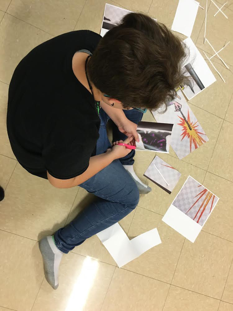 This is a photo of a student cutting out decorations. 