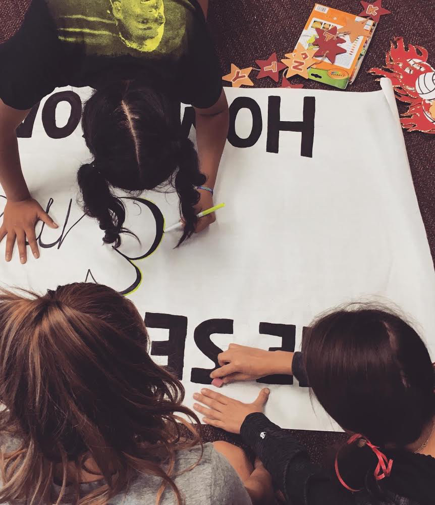 Students are working on last minute fixes to their hallway banner. 